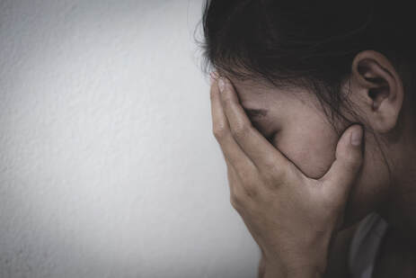Picture of a young woman with her face in her hands looking upset. If you need help with painful sex, a Plymouth, MN sex and relationship therapist can help. Read on for help in Plymouth, MN 55369 | 55361 | 55391